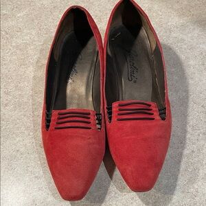 These are a pair of vintage red suede flats from the brand Garolini